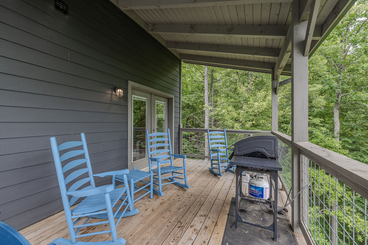 Step outside to enjoy the quiet mountain setting from the cabin’s covered deck.
