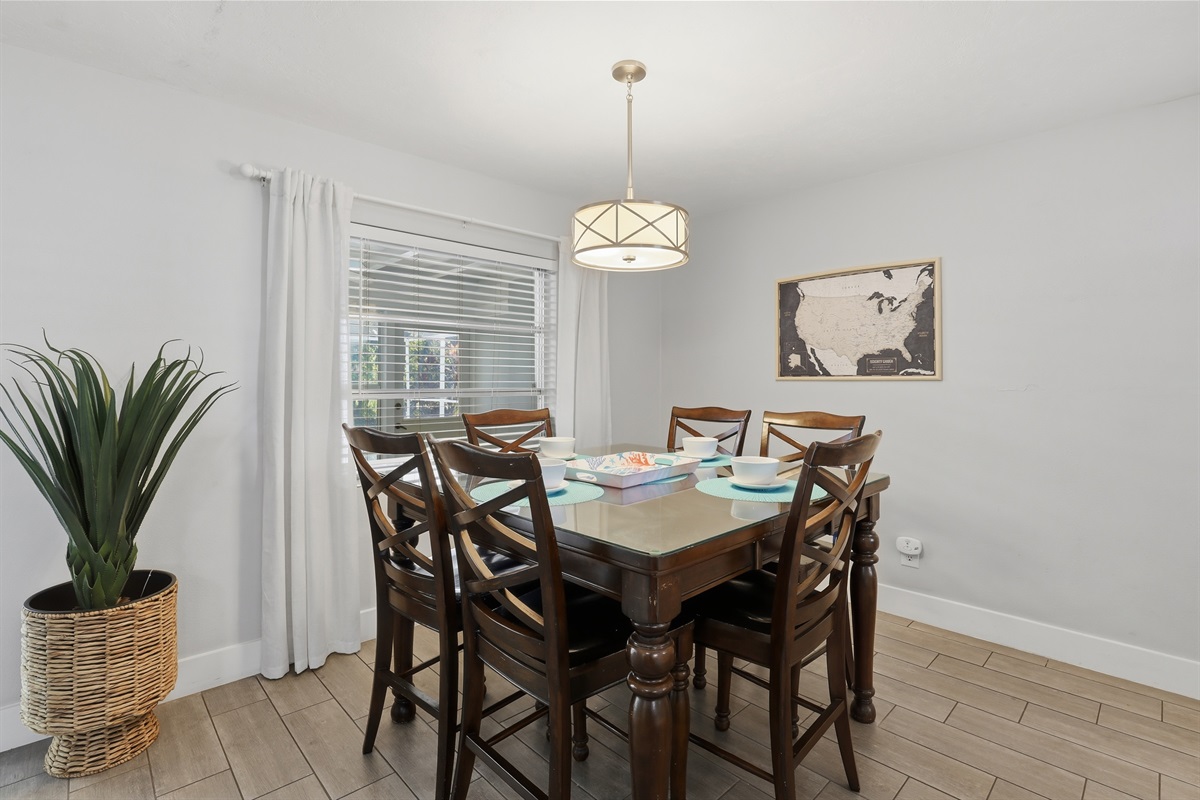 Dining table seats 6 with extra chairs in the game room as well.