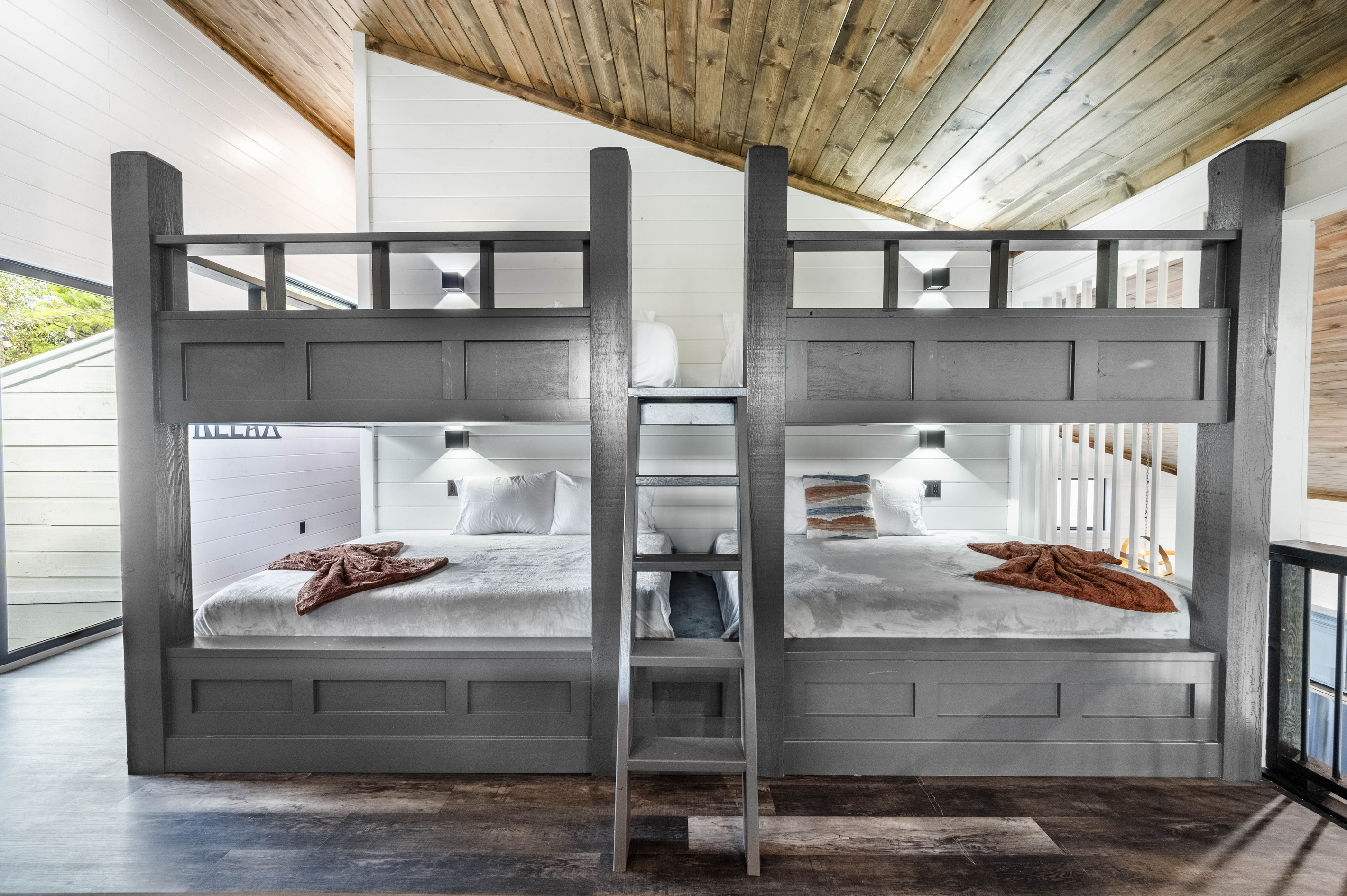 Game room features spacious queen-sized bunk beds designed with comfort in mind offering an unique sleeping arrangement. Enjoy the convenience of having extra sleeping space right near the entertainment