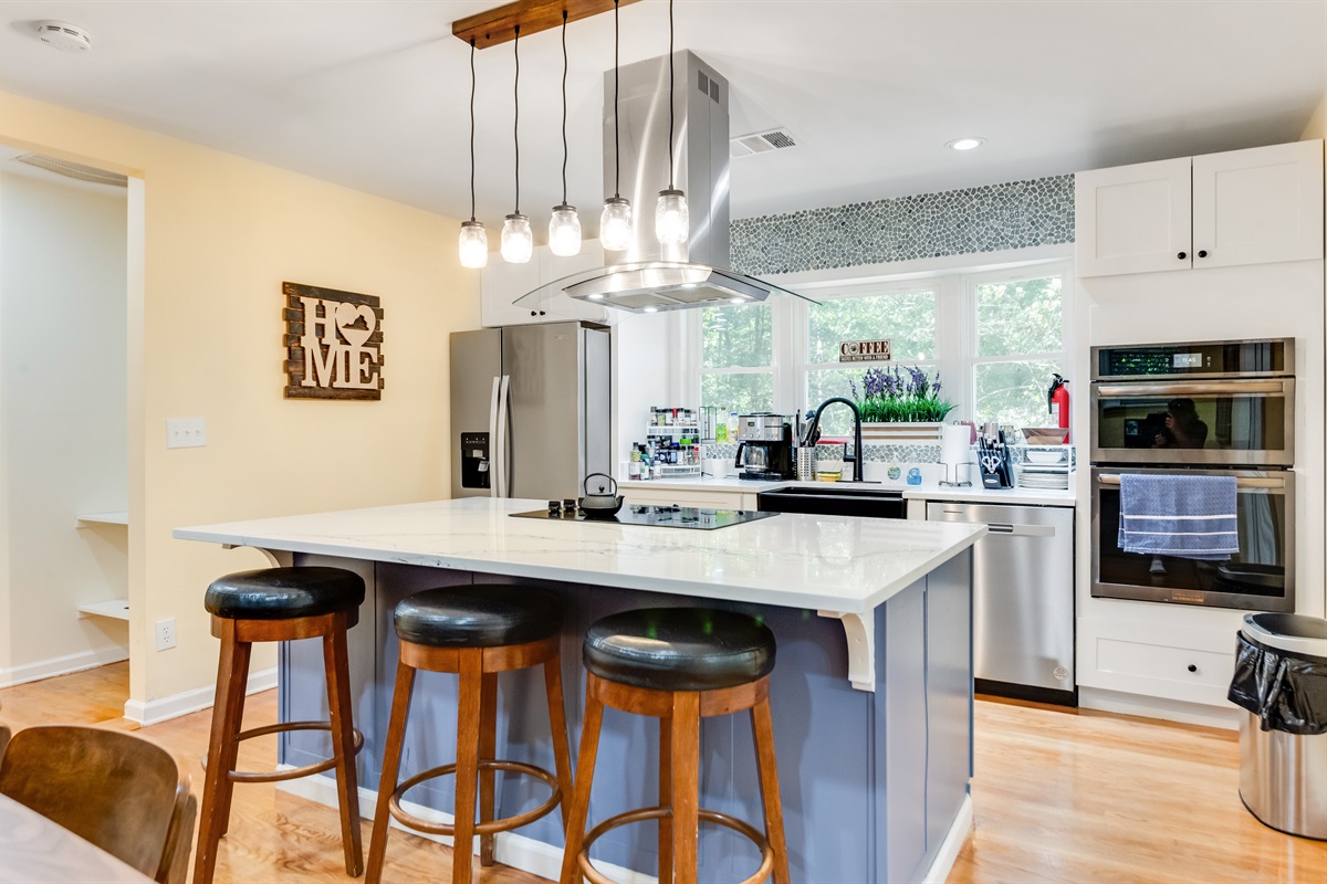Kitchen: Bright and inviting space with modern appliances and stylish bar seating for culinary adventures!