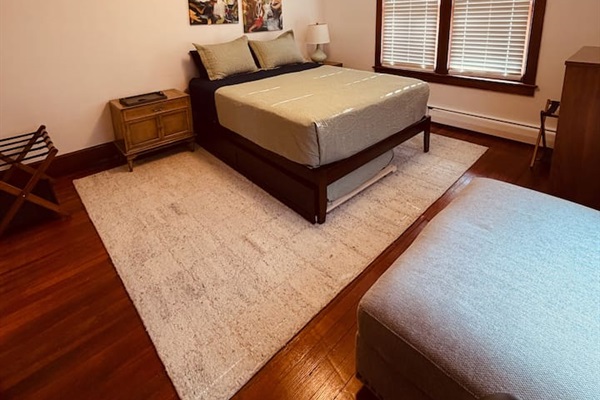 Primary bedroom with queen bed with twin trundle-soft linens, and natural light