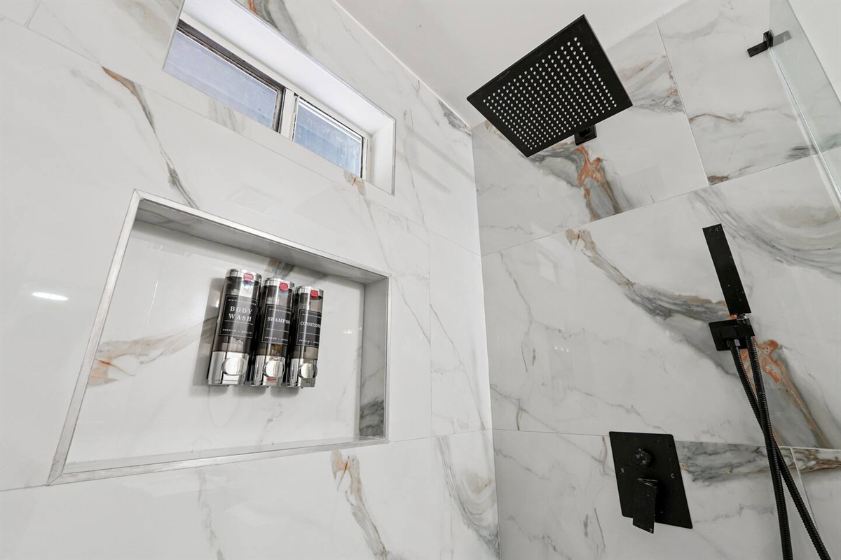 Full bathroom thoughtfully stocked with essentials including body wash, shampoo, conditioner, cotton pads, and Q-tips everything you need for a comfortable and refreshing stay.