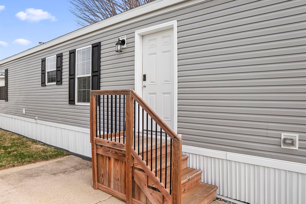 Easy-access front entry with small porch and steps, offering a smooth and welcoming arrival.