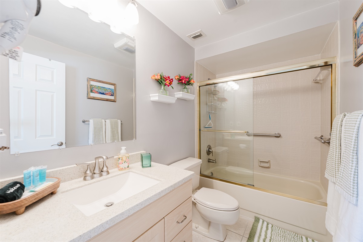 Clean and bright guest bathroom with tub/shower combo—perfect for families and longer stays
