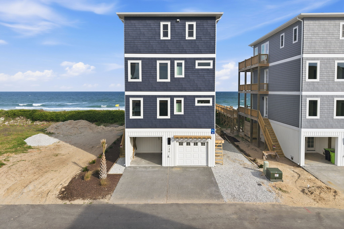 Street-side exterior showing driveway, garage, and main front fa&ccedil;ade