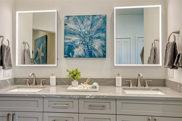 Dual backlit vanity mirrors in the master bath ensure a perfect shave and makeup application