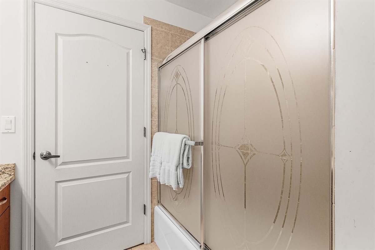 Inviting guest bathroom with a tub/shower combo perfect for any stay!