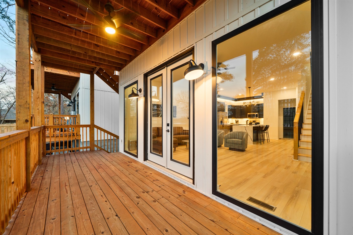 Large doors connect the indoor living space directly to the deck for easy outdoor access.