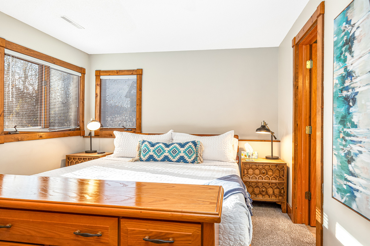 Bedroom 3 featuring a King bed and a Roku Smart TV, and an ensuite bathroom; one of three bedrooms located on the lower level.