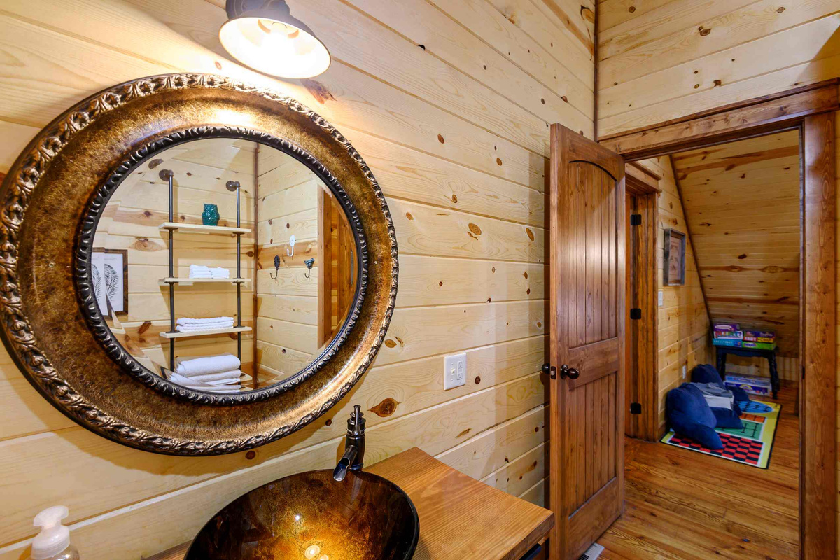 Bathroom Retreat: Experience rustic charm with a stylish vanity and playful decor for relaxation!