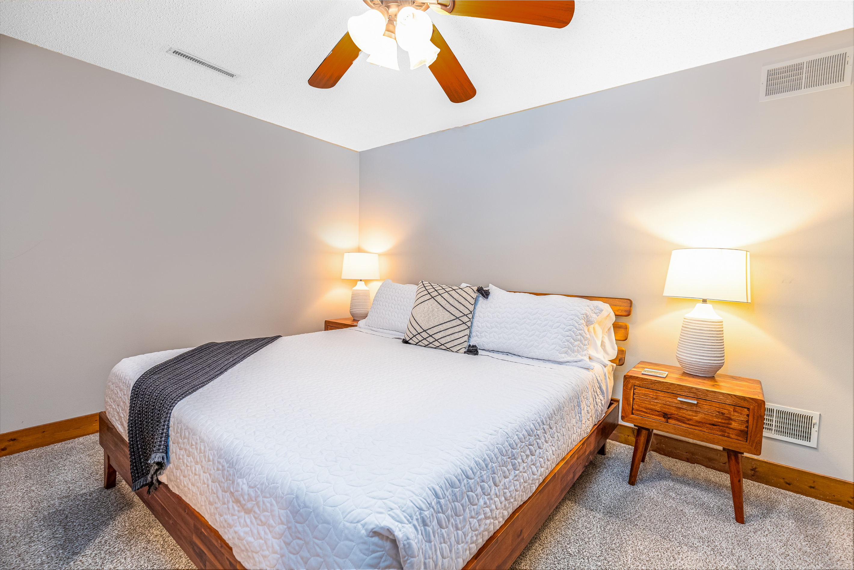 Bedroom 4 featuring a King bed and a Roku Smart TV, and an ensuite bathroom; one of three bedrooms located on the lower level.
