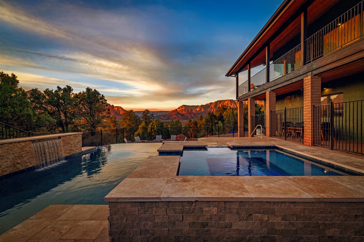 Infinity pool with waterfall and breathtaking red rock views.