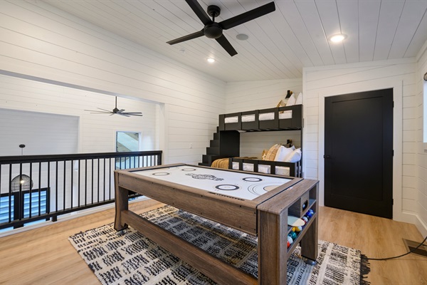 Challenge friends and family to a game of air hockey or pool in this versatile upstairs retreat.