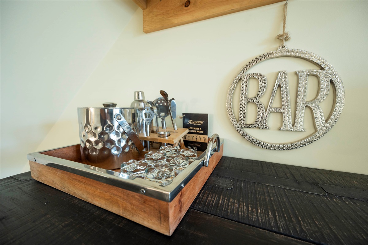 Chic home bar setup with stylish drinkware and rustic wooden accents.