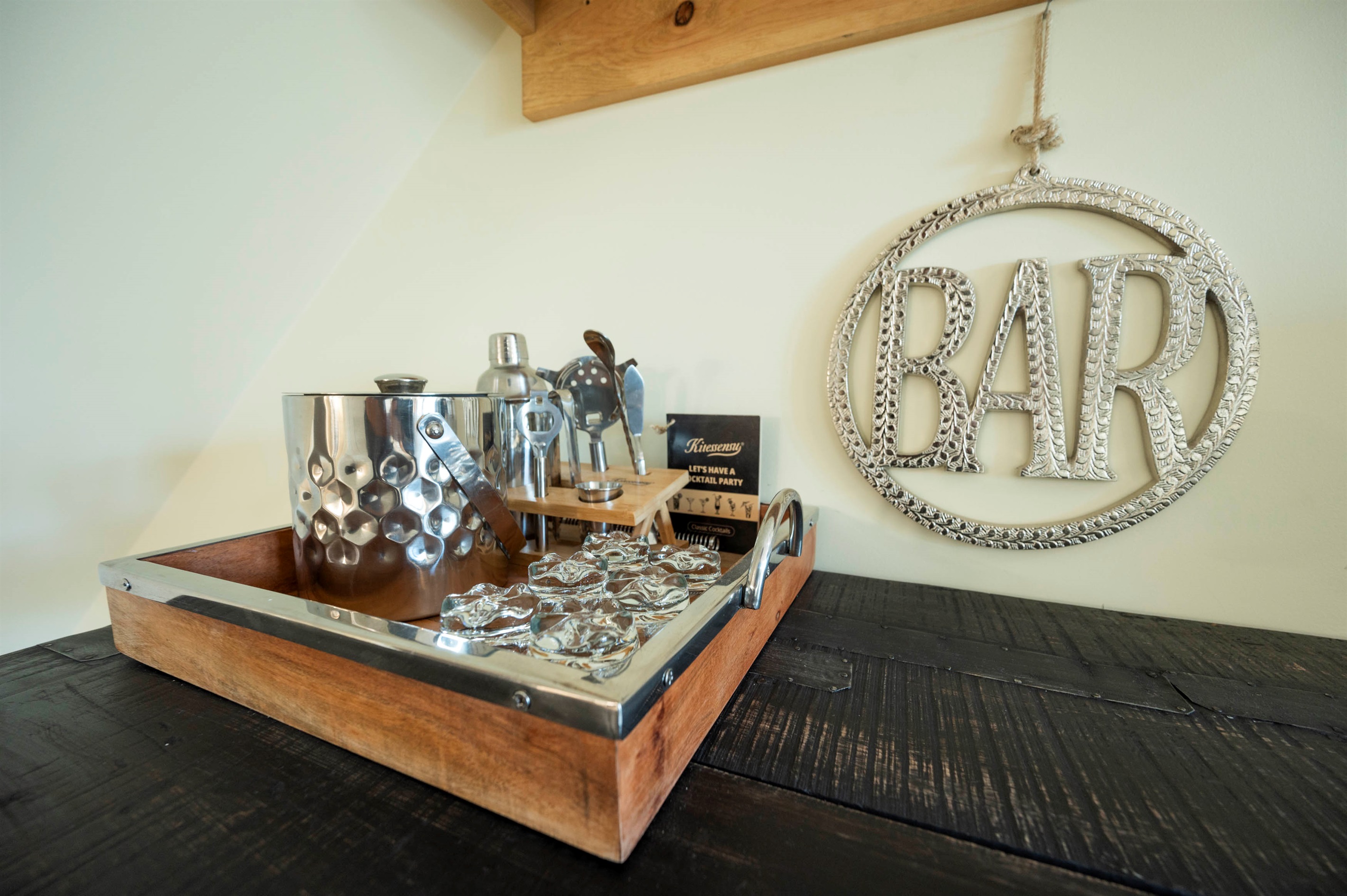 Chic home bar setup with stylish drinkware and rustic wooden accents.