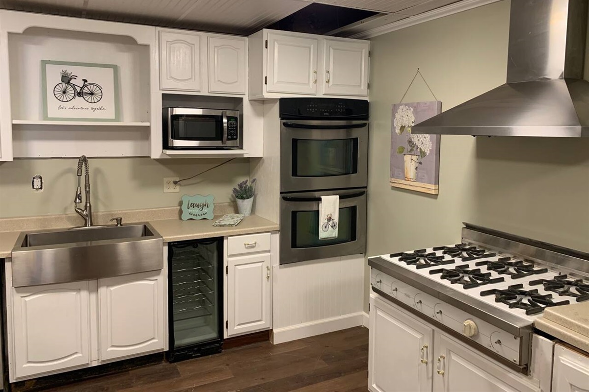 6 burner stove and double over are in this fully stocked kitchen.