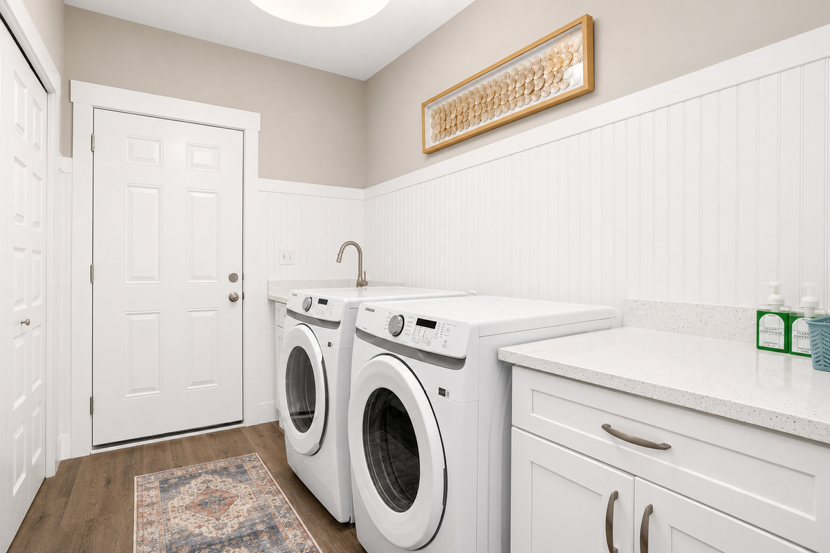Enjoy the convenience of a dedicated laundry room with a full-size washer and dryer, making it easy to refresh clothes, towels, and beachwear during your stay.