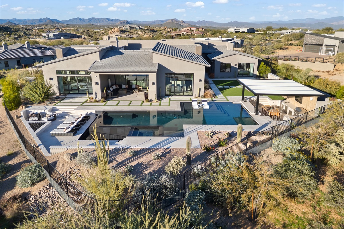 Architectural Masterpiece: 4,600+ sq. ft. Indoor-Outdoor Flow with six 10-foot pocketing doors disappearing to merge the Great Room with the desert landscape.  a