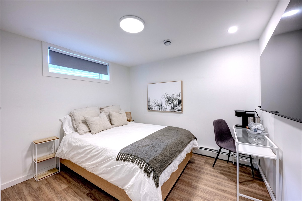 Comfortable bedroom with blackout blinds and modern finishes.