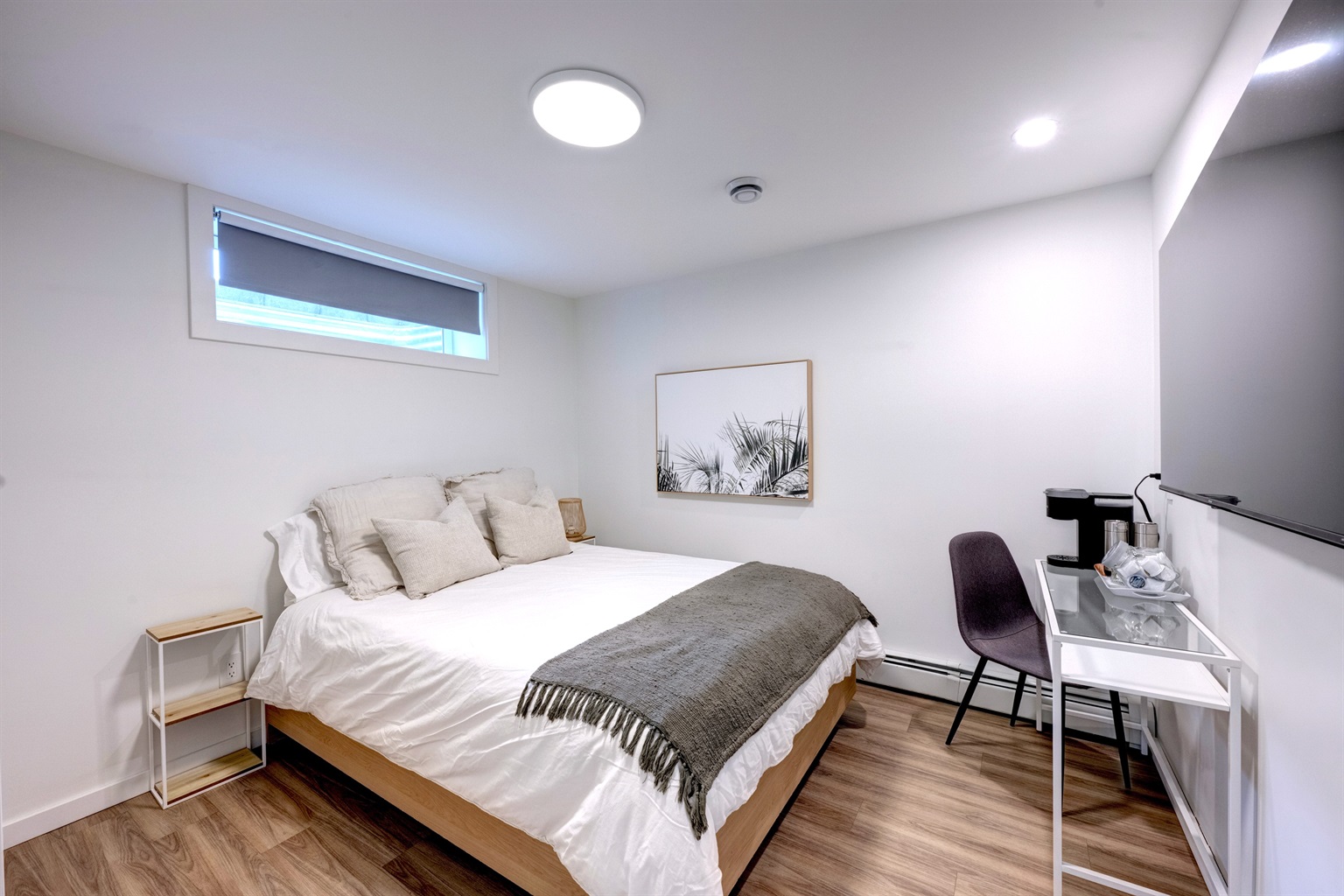 Comfortable bedroom with blackout blinds and modern finishes.