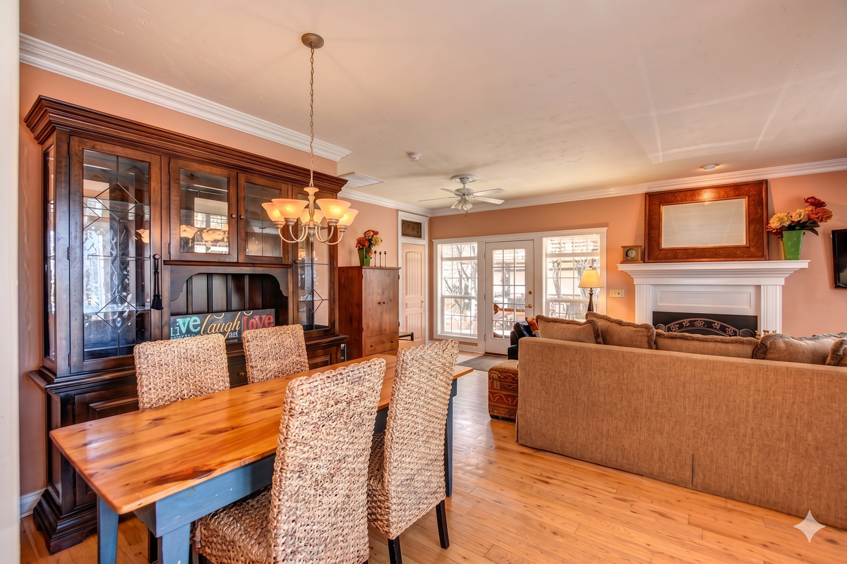 The home's open floor plan seamlessly connects the kitchen, living room, and dining room, creating a spacious and airy feel perfect for entertaining and spending time together.