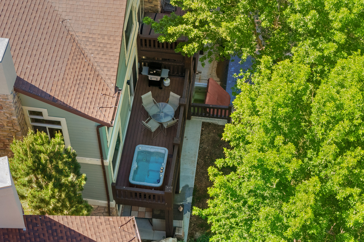 Aerial view of the private hot tub deck nestled among the trees, offering a peaceful retreat with easy access to the beauty of Pineview Reservoir and Ogden Valley.