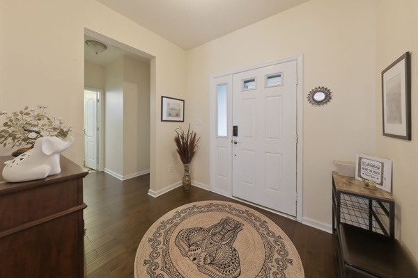 Large foyer equipped with shoe storage, a large coat closet and bench for managing shoes and kids!