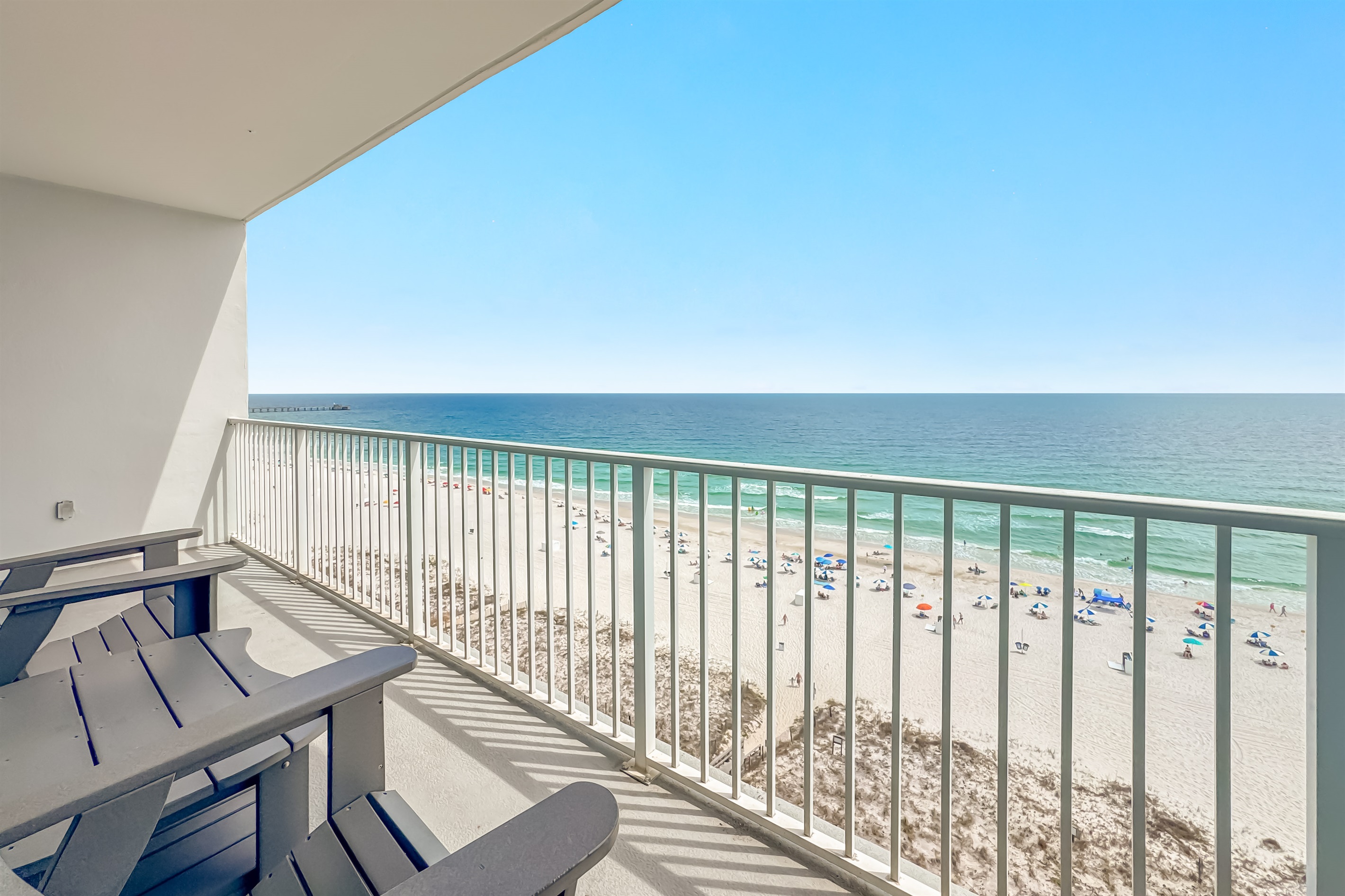 Gain a new perspective on coastal beauty with this panoramic view.  Witness the vastness of the beach and the shimmering sea.