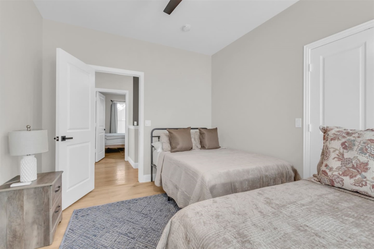 Guest room with 2 full beds and plenty of natural light.