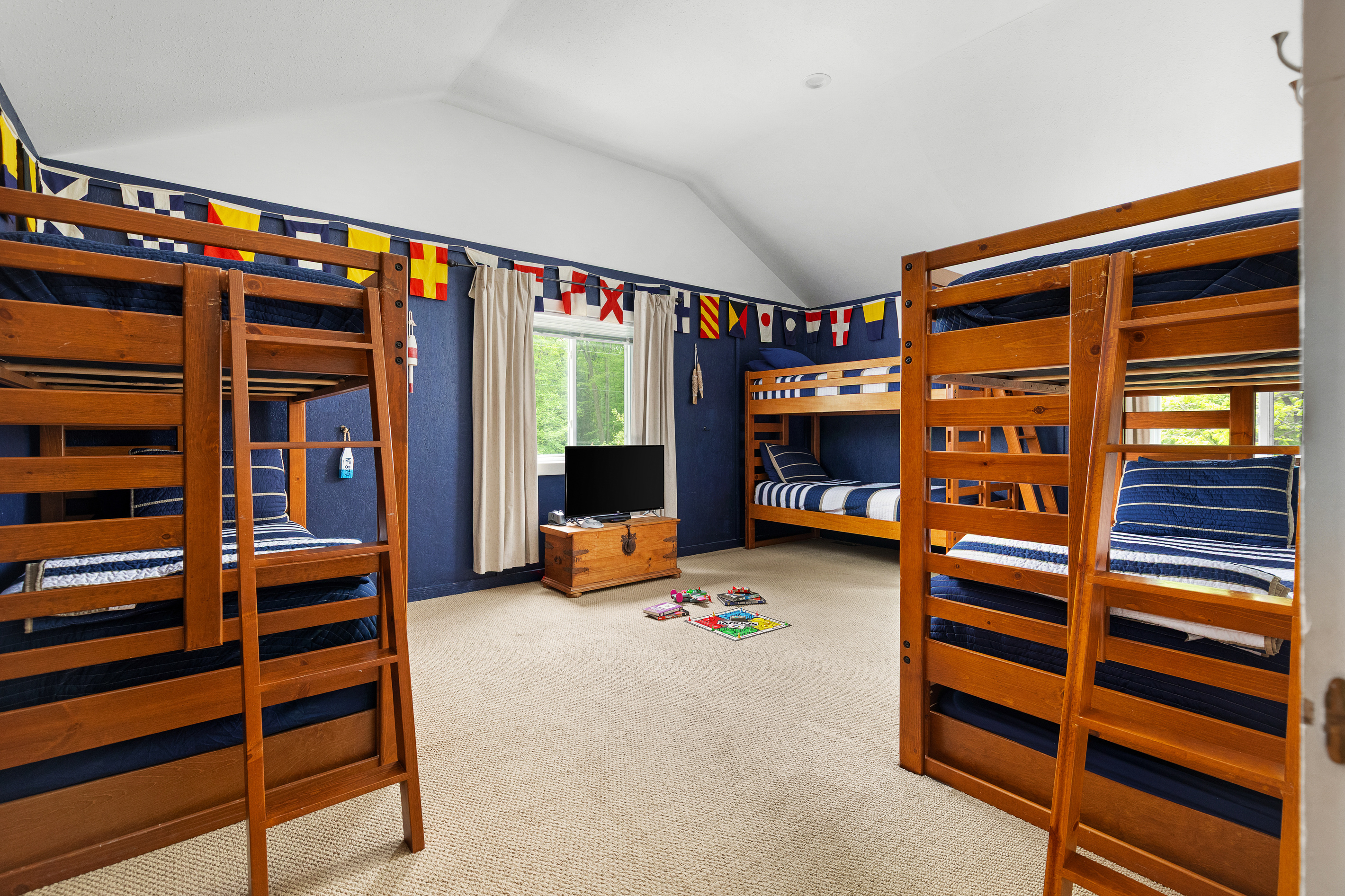 3 Bunks with 2 trundles give you 8 twin beds in this room with black out curtains.