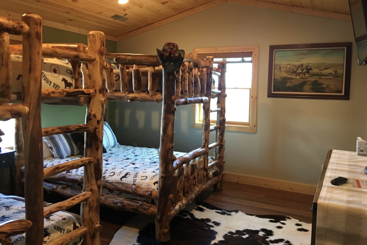 Let the little ones stay in the Cowboy Bunk Bed Room! Fun for everyone with 2 queen-sized bunk beds.