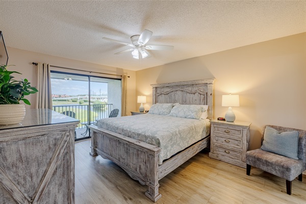 Master bedroom with ceiling fan, ensuite bathroom, smart TV and clothing storage