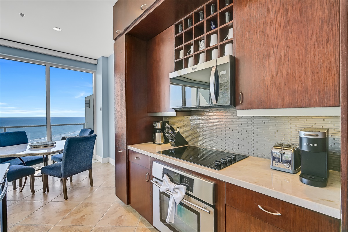 Kitchen, onyx countertops, knives, Keurig, coffee pot, microwave, stove top, stove, tea kettle, dishwasher, garbage disposal