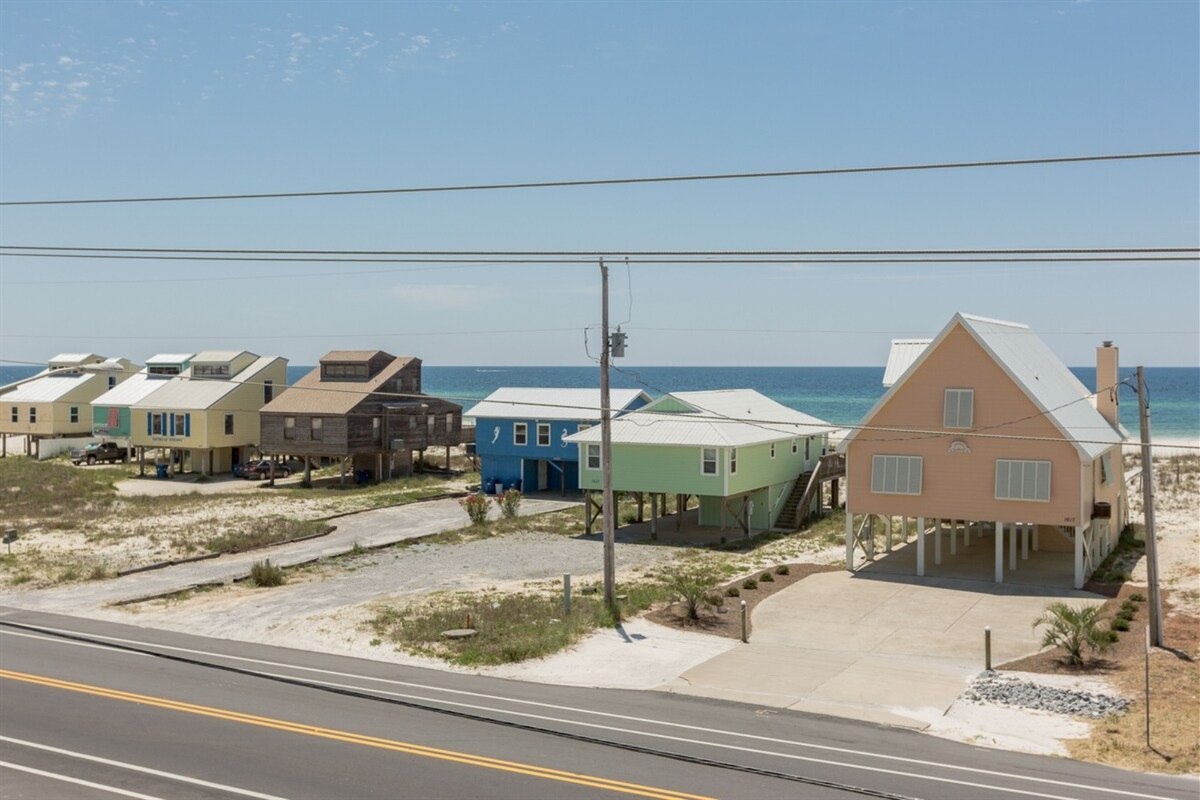Beautiful covered front porch with Gulf views and plenty of seating 