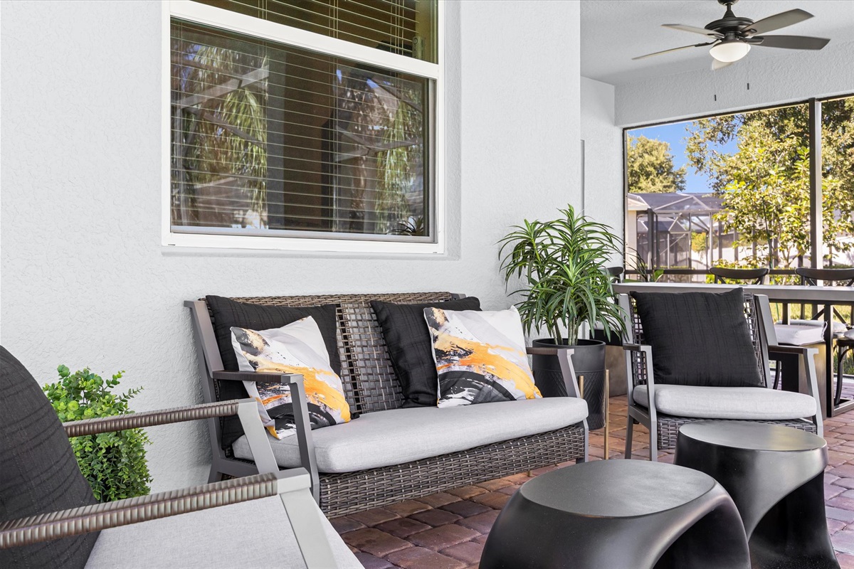 Relax in this cozy outdoor lounge with plush seating and ceiling fan comfort — your ideal spot for morning coffee or sunset chats.