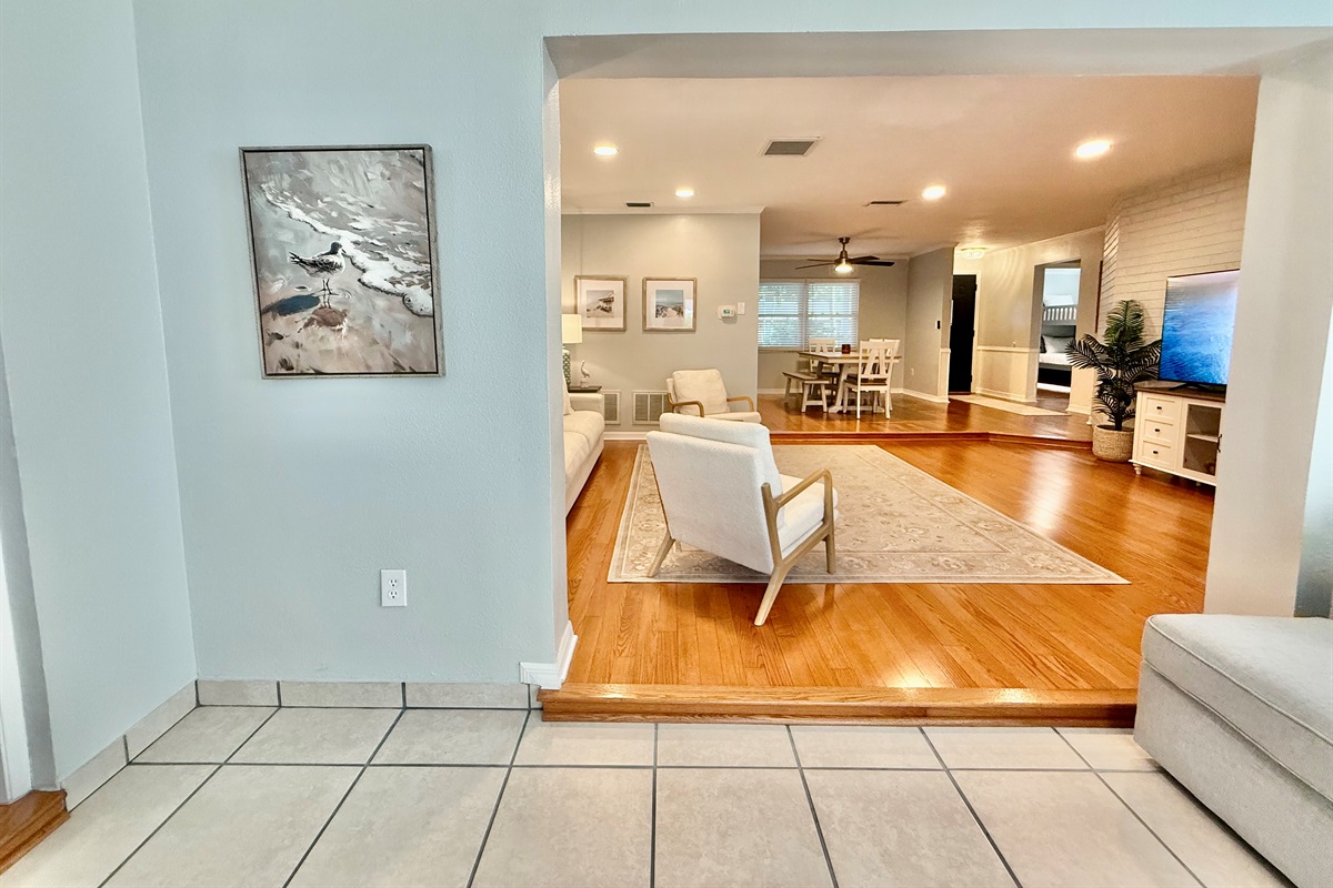 Your favorite streaming apps are just a click away on the large smart TV, surrounded by cozy armchairs and a deep, soft sofa.