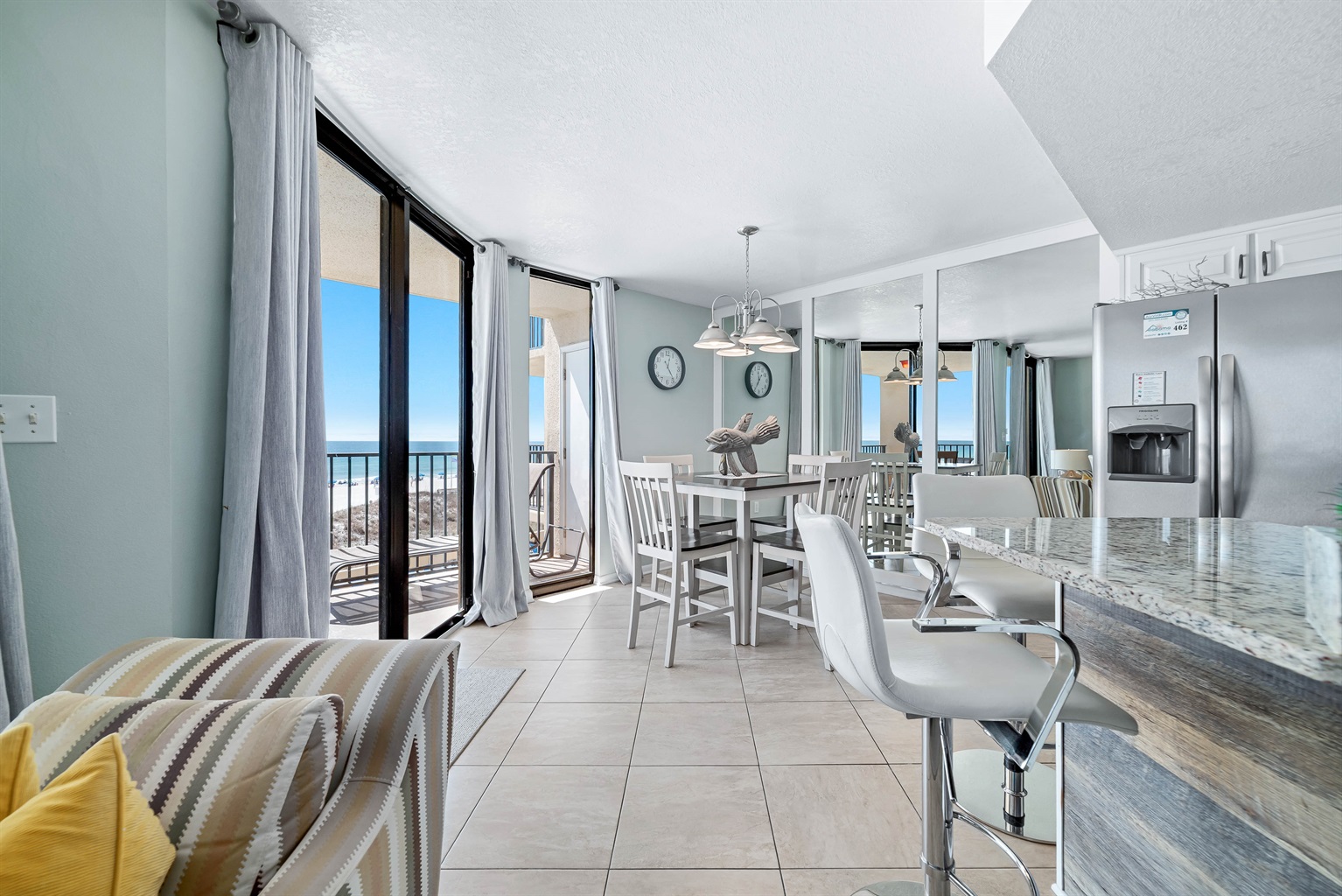 This stylish dining space features comfortable seating, charming nautical decor, and floor-to-ceiling glass doors that bring the beach right to your table. Complete with direct access to the balcony, it's the ideal setting for making mealtime memories.