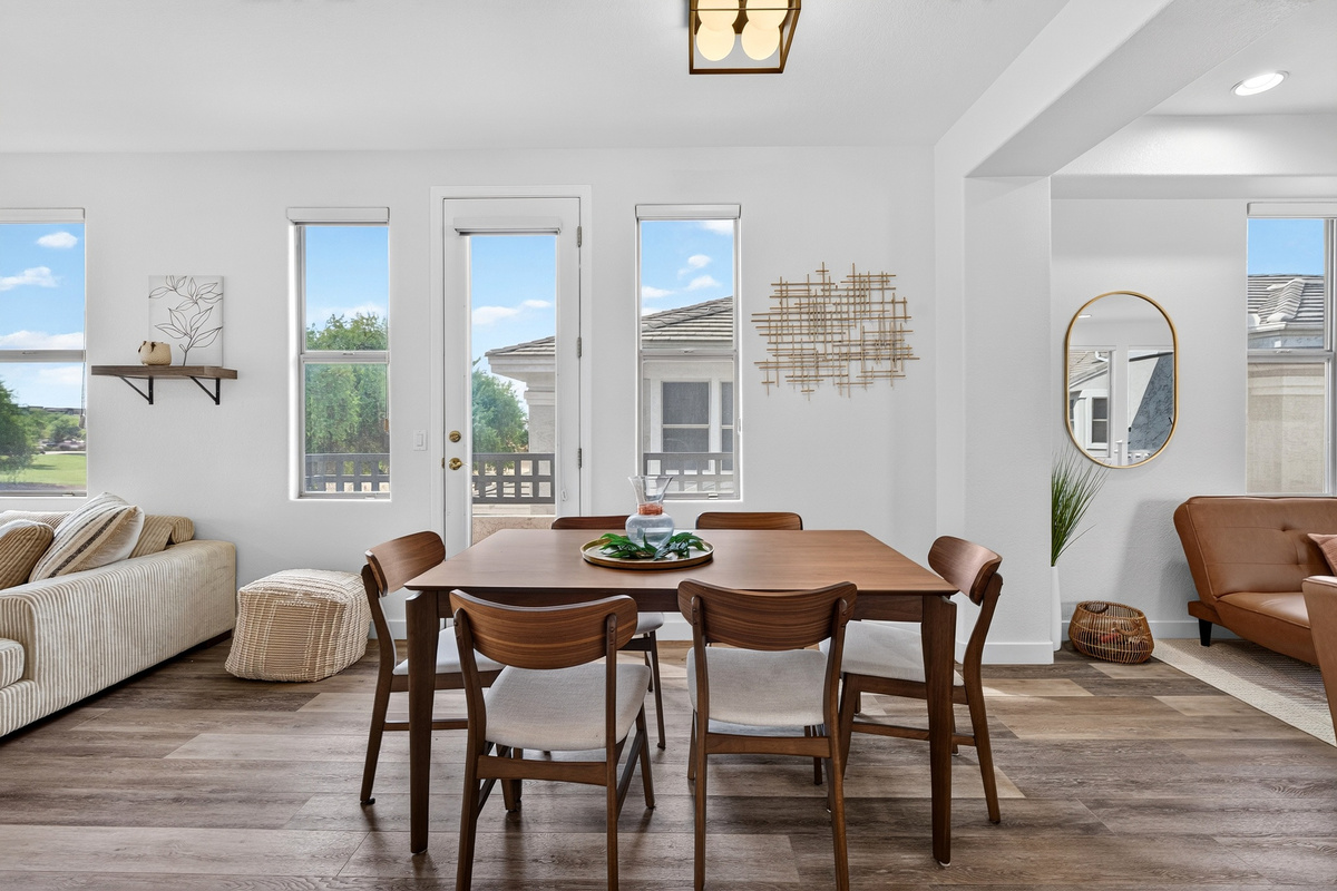 Dining area with table seating, natural light, and an open view toward for the lounge space and living area
