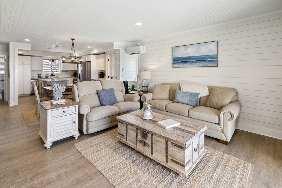 The main living area opens to the Gulf-view deck &mdash; open layout, queen sleeper sofa, and plenty of room for everyone.