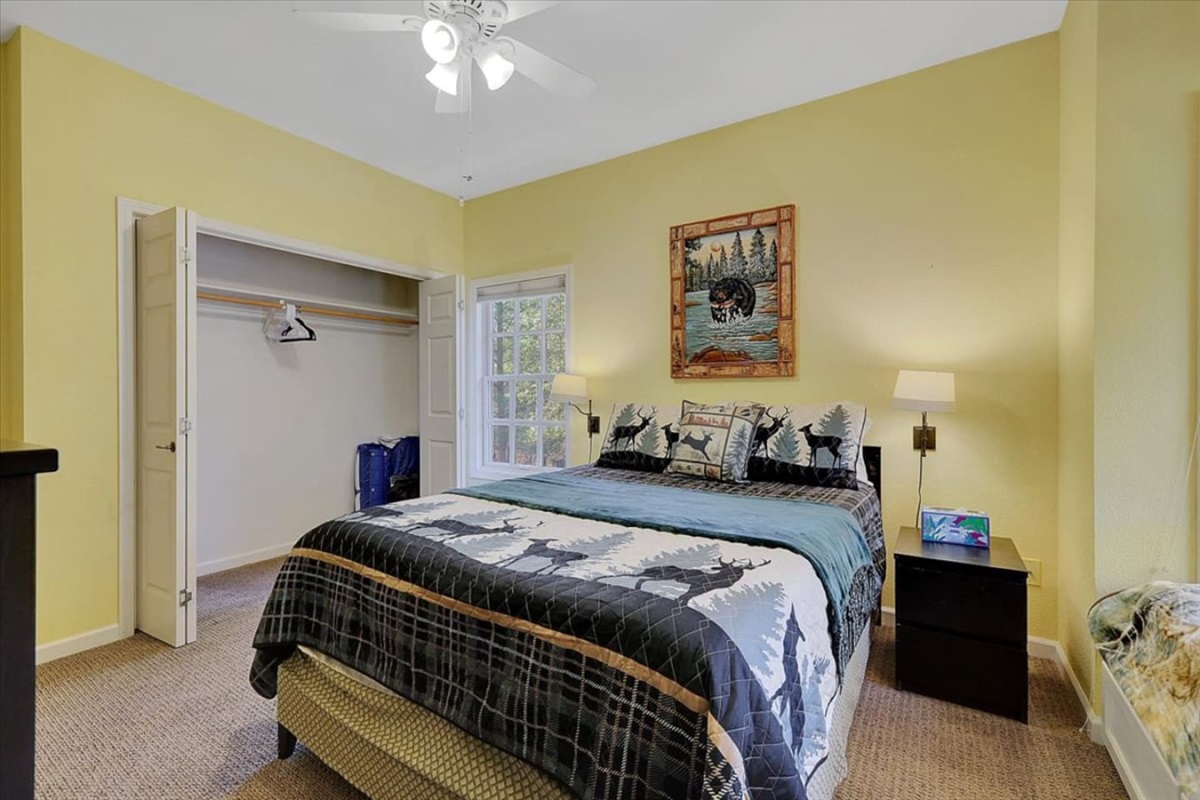 Bedroom 2 with a queen bed, twin bed, and rollaway twin for flexible sleeping space.
