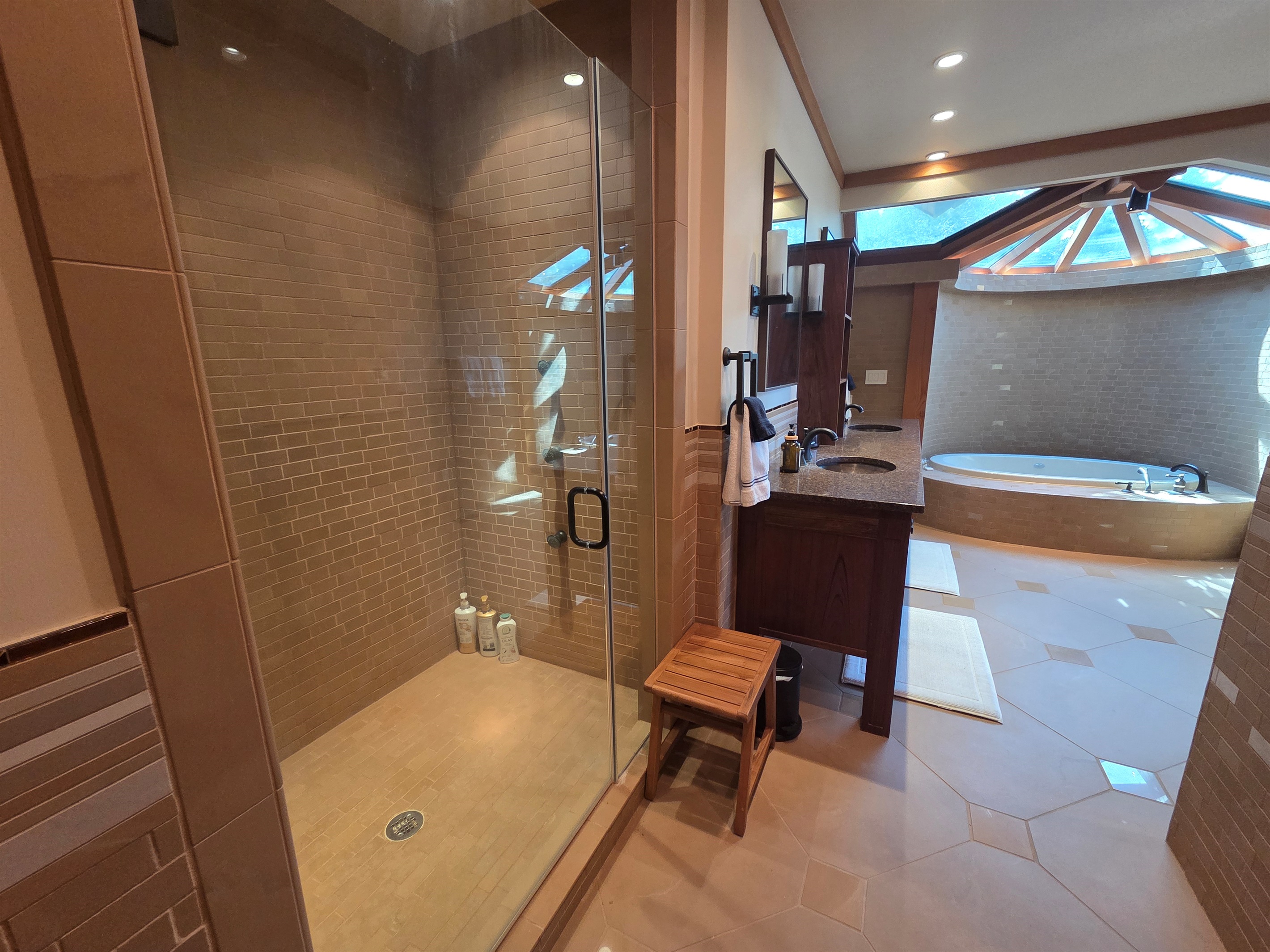 The master bathroom offers a spa-like experience with a deep soaking tub and a large walk-in shower designed for comfort and relaxation.
