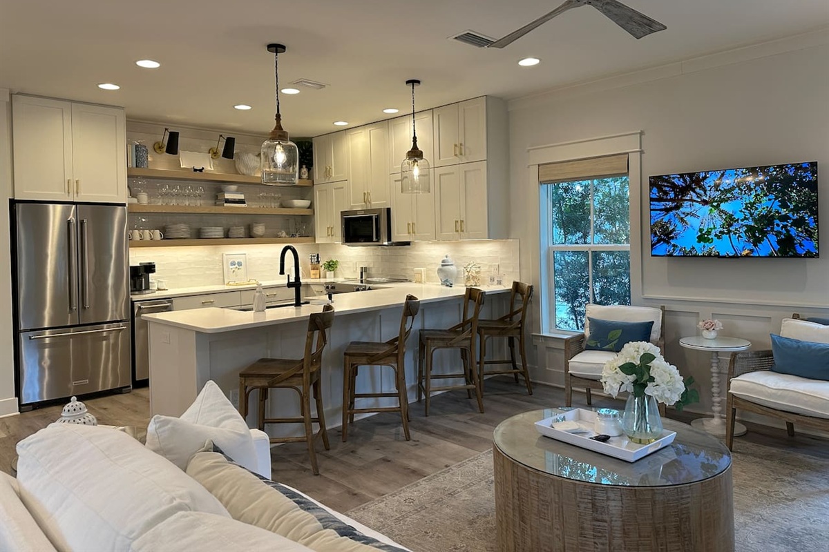 Fully stocked kitchen with KitchenAid refrigerator with filtered water and ice, a separate ice maker, stove, oven, microwave, and coffee/tea bar.