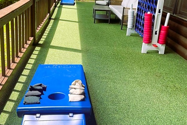 Relax or play on the lower deck with peaceful forest views. Perfect for family time with cornhole, Connect 4, and fresh mountain air in our Blue Ridge cabin in the Aska Adventure Area.