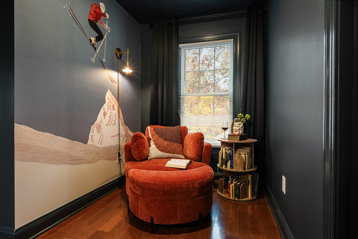 A playful mural, comfy chair, and shelves of books make this corner ideal for kids, teens, or anyone who wants to curl up and escape.