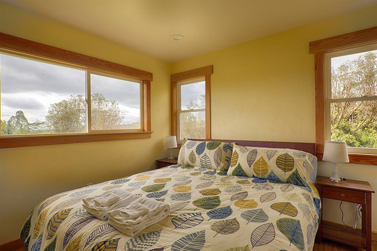 Enjoy a beautiful and comfortable king bed downstairs with authentic craftsman style finishes. The windows on each side of the bed open up to Kikala stream, letting the sound of the river lullaby you to sleep.