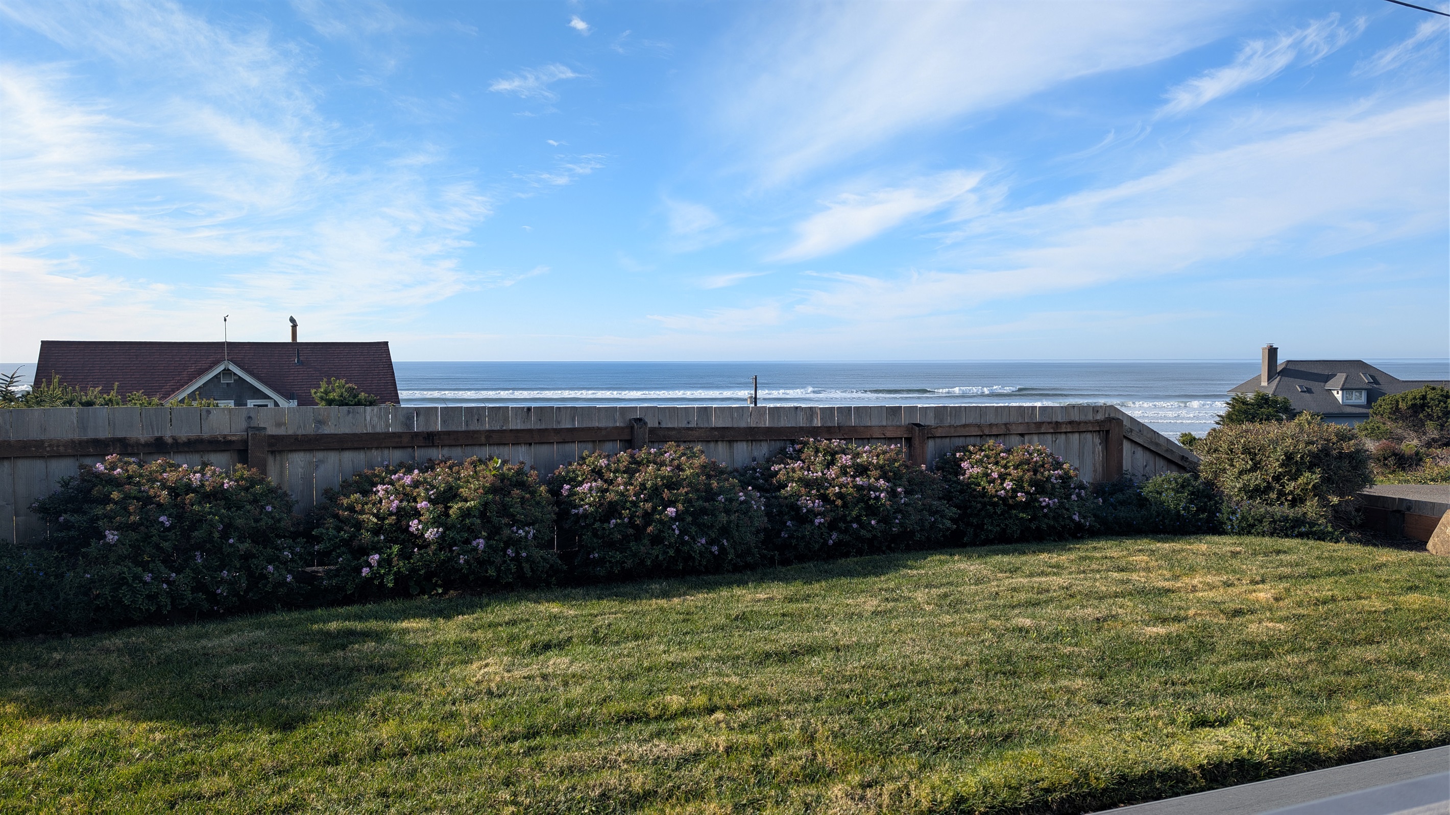grassy area in front of deck just partially fenced