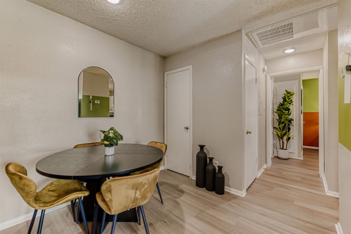 A warm and inviting dining nook featuring modern decor, cozy seating, and a touch of greenery for a fresh, stylish vibe.