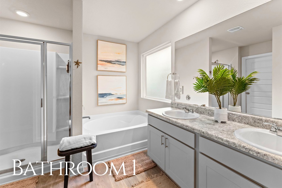 Bathroom 1 is spacious and bright, featuring dual sinks and plenty of room for everyone to get ready without feeling crowded.