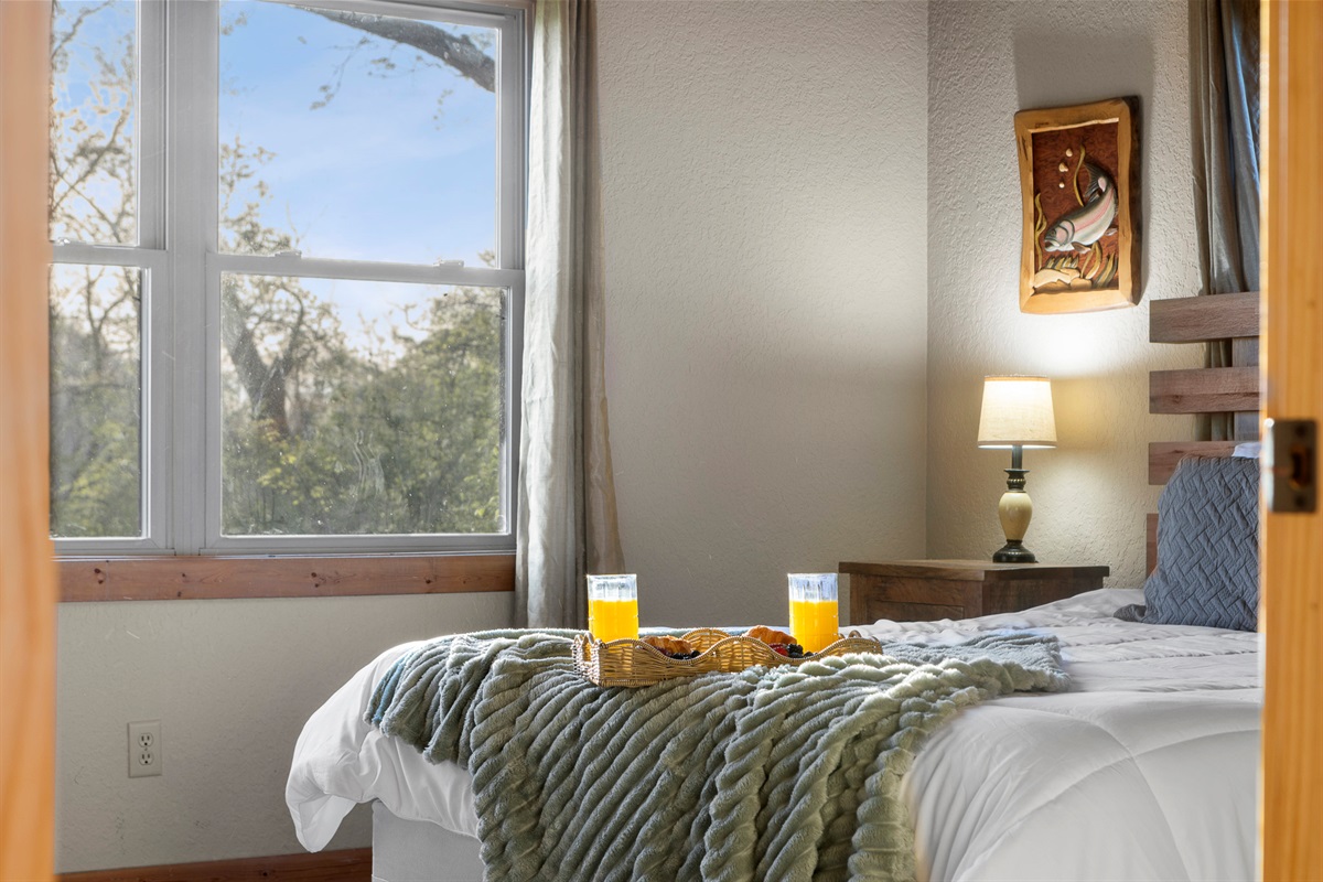 Bedroom Retreat: Sip morning juice while soaking in stunning nature views from your serene getaway!

