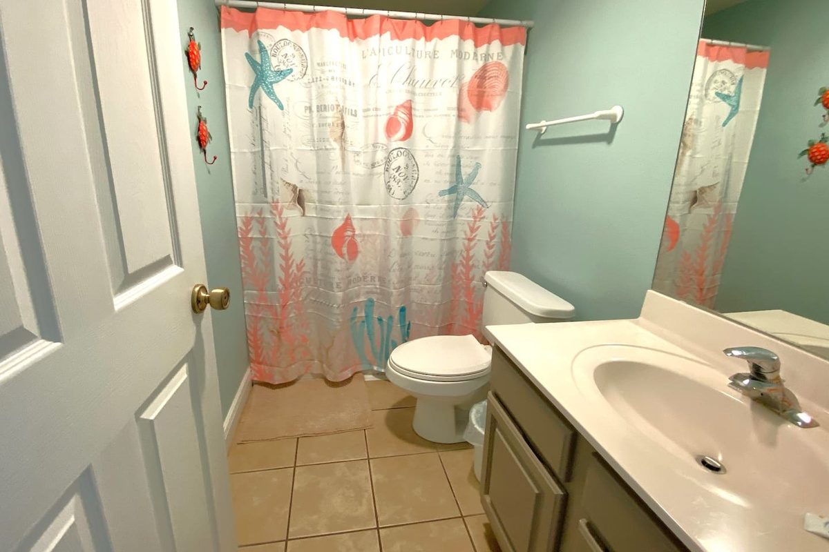Soak off the sand the moment you're back &mdash; the main-level bath has a full tub/shower combo right where you need it, before sand hits the rest of the house.